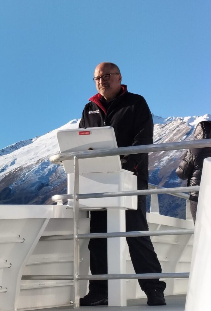 A man on a deck of a boat