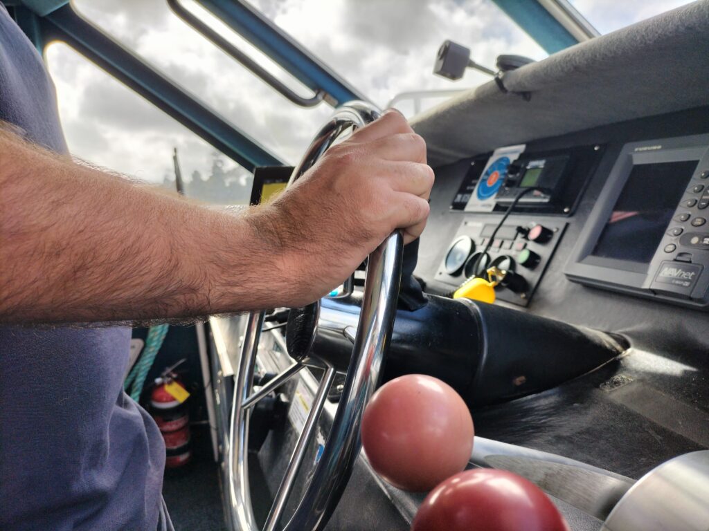 A man's hands on the wheel of a vessel | Skipper | Marine & Maritime